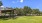 The grounds at our apartments in Orlando, featuring a grassy field and a view of the apartment complex. 