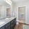 Model bathroom at our apartments in Orlando, featuring granite countertops and a view of the closet. 