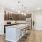 Model kitchen at our apartments in Orlando, featuring wood grain floor paneling and granite counter tops. 