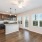 Model kitchen at our apartments in Orlando, featuring wood grain floor paneling and granite counter tops. 