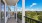 Photograph of a model porch at our apartments in Orlando, featuring a view of the grounds and the apartment complex.