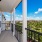 Photograph of a model porch at our apartments in Orlando, featuring a view of the grounds and the apartment complex.