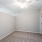 Empty bedroom at our apartments in Orlando, FL, featuring beige carpet and beige walls with overhead lights