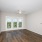 Empty bedroom at our apartments in Orlando, FL, featuring beige carpet and beige walls with overhead lights