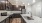 Model kitchen at our apartments in Orlando, featuring wood grain floor paneling and granite counter tops. 